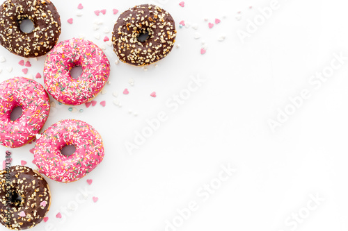 Top view of colorful glazed donut swith sprinkles, copy space