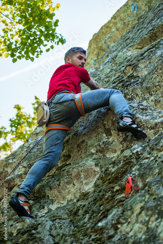 Male rock climber on challenging route