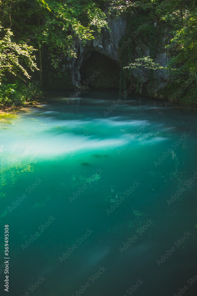 Naklejka premium Krupajsko Vrelo (The Krupaj Springs) in Serbia, beautiful water spring with waterfals and caves. Healing light blue water.