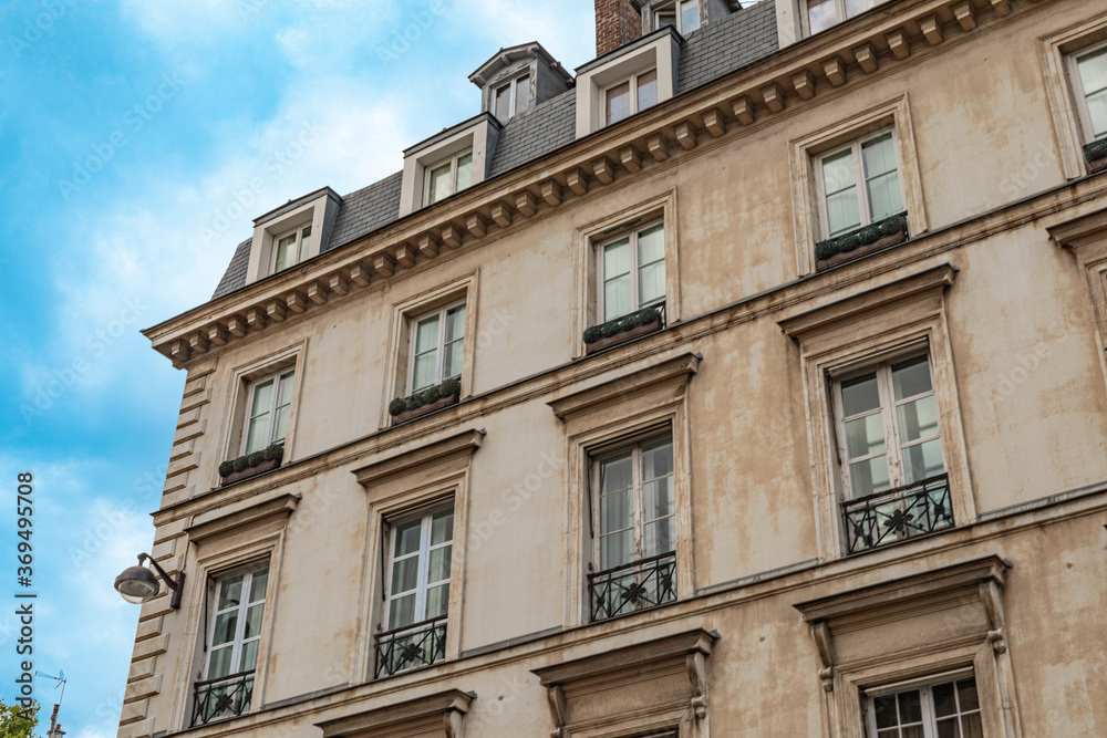 Typical old Paris architecture, facades of residential buildings with balconies and mansards