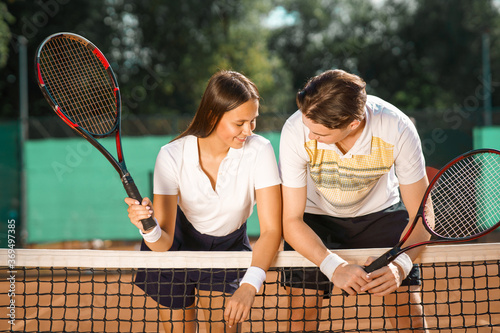 Young couple talking after playing tennis © Andrii 