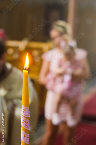 Burning candle at Orthodox christening with blurred background