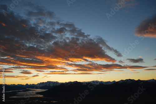 Dramatic sky cluds. Orange lenticular cluds. Sunset. South Patagonian sky.