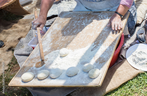 Woman preparing doughts with flour for baking photo