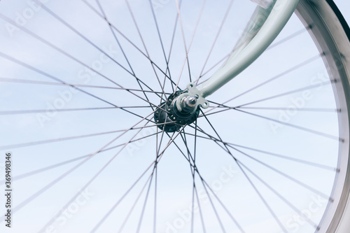 Close-up of a bicycle wheel on a blue sky