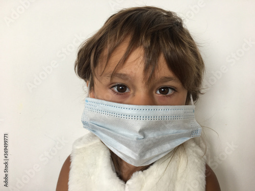 portrait of a child in a medical mask from covid