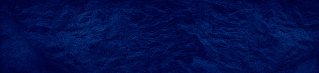 Dark blue background. Abstract blue background. Toned stone texture. Bright banner for your design.