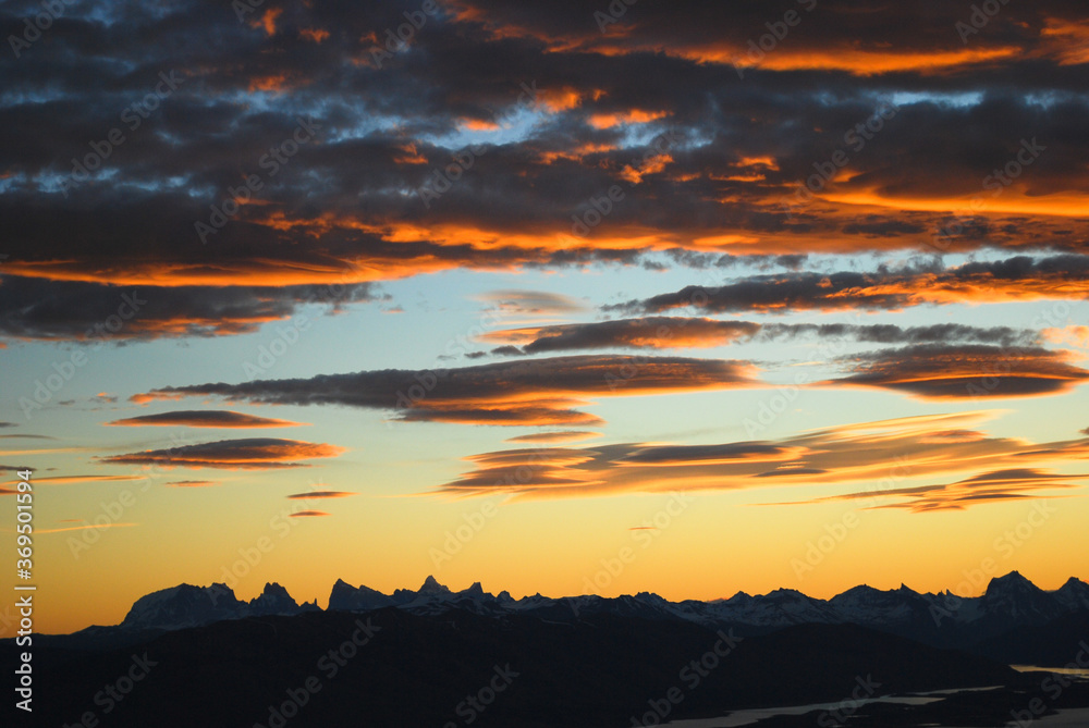 Obraz premium Dramatic sky cluds. Orange lenticular cluds. Sunset. South Patagonian sky.
