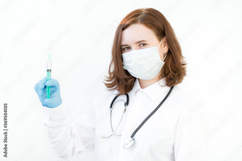Portrait of a doctor in uniform, holding a syringe in his hand on a white background. Healthcare workers in the Coronavirus Covid19 pandemic Portrait of a doctor in uniform, holding a syringe in his hand on a white background. Healthcare workers in the Coronavirus Covid19 pandemic