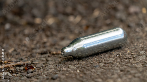 Close-up of a discarded Nitrous oxide gas canister