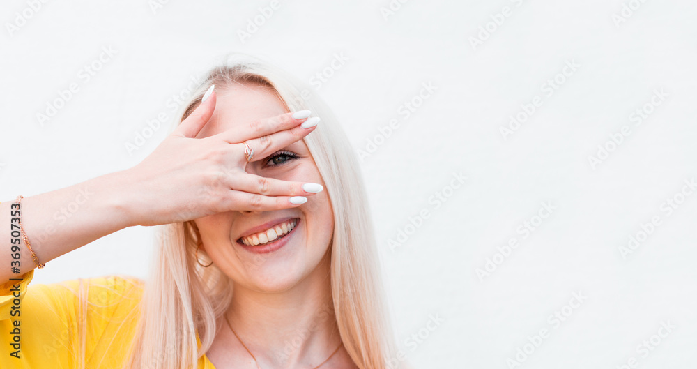 Happy woman looking between fingers