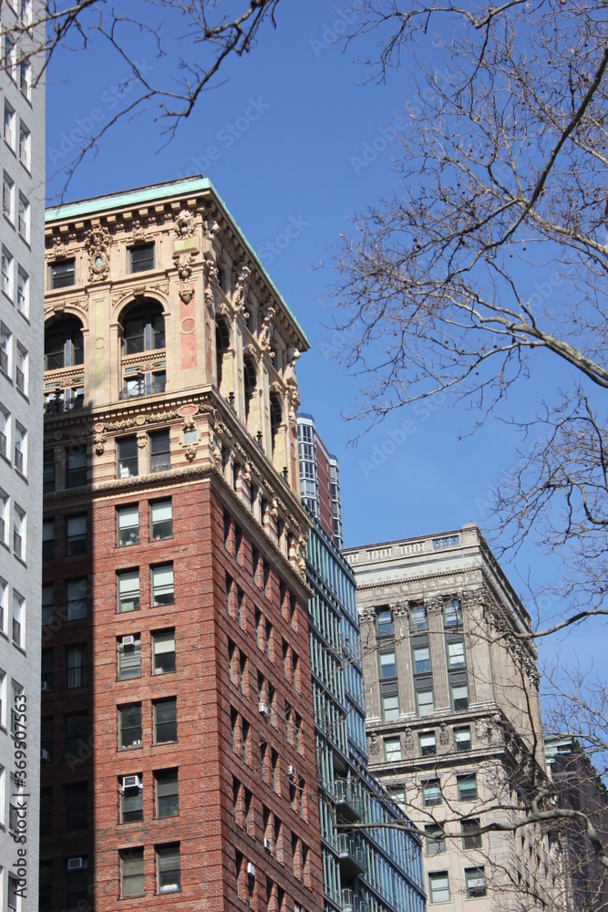 Obraz premium Brown apartment building with arched windows and facade ornaments