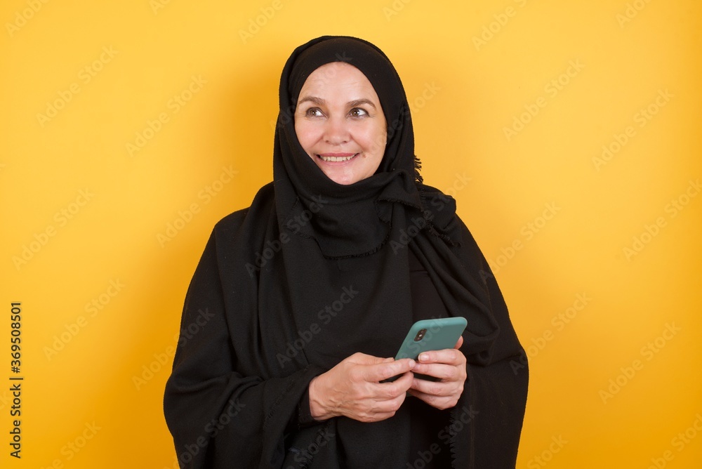 Copyspace photo of charming Middle aged muslim woman wearing black hijab  pretty attractive gorgeous sweet lovely beautiful girlfriend stupor with something occurring in social media