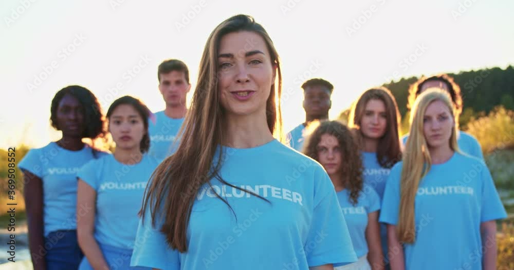 Beatiful young Caucasian female activist with a voluntary organisation. Attractive eco volunteer looking at camera and saying: I Am a Volunteer. Volunteering, environmental, nature conservation. Beatiful young Caucasian female activist with a voluntary organisation. Attractive eco volunteer looking at camera and saying: I Am a Volunteer. Volunteering, environmental, nature conservation.