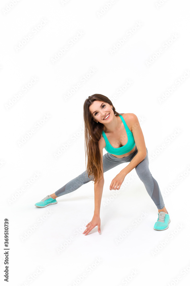 Sports girl doing workout on a white background