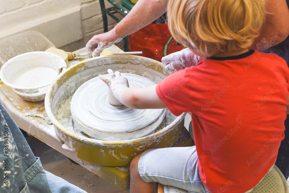 Children making pottery during ceramic lesson with clay Children making pottery during ceramic lesson with clay