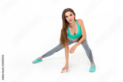 Sports girl doing workout on a white background