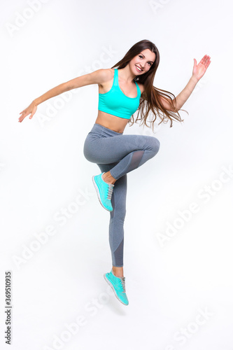 Sporty girl doing exercise on white background