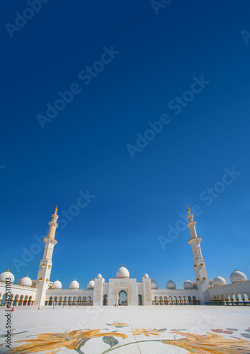Mosque Sheikh Zayed bin Sultan Al Nahyan ABU DHABI. Two towering towers and white domes against the blue sky photo