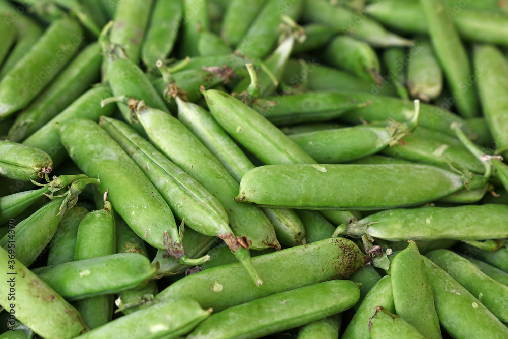 Close up green peas pods on retail display