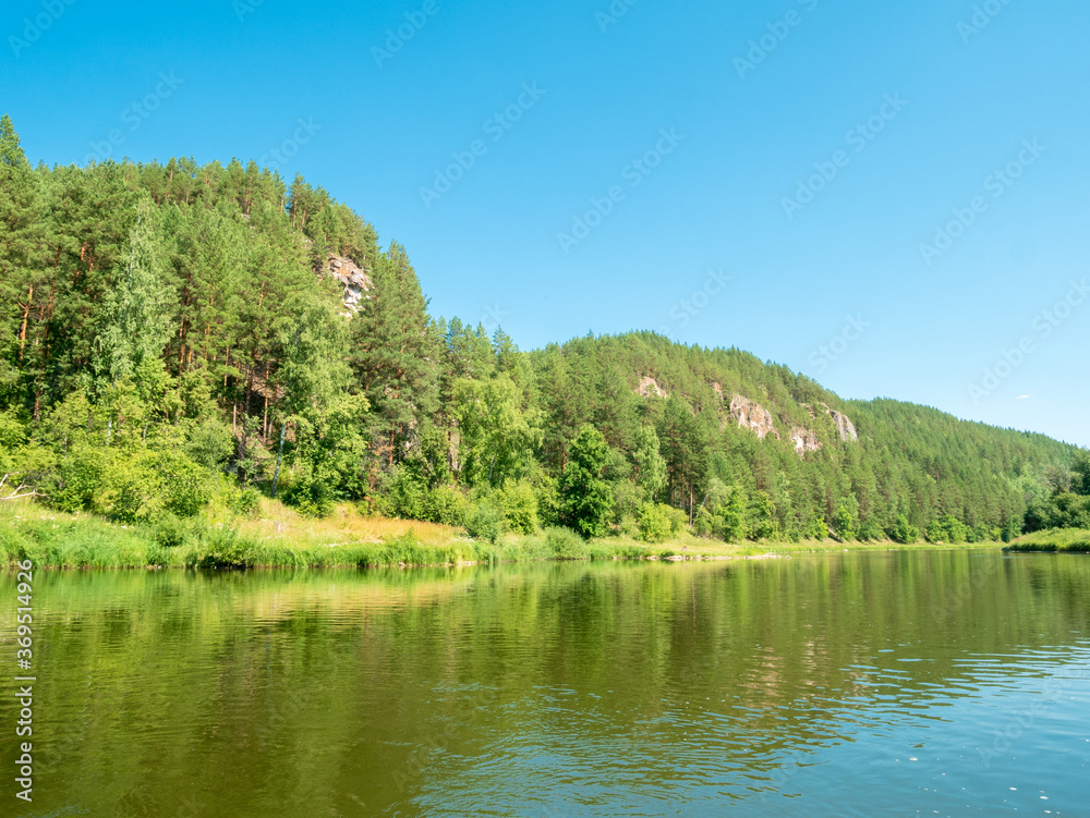 Nature, river, mountains, forests on a summer day, Rocky shore with the forest.