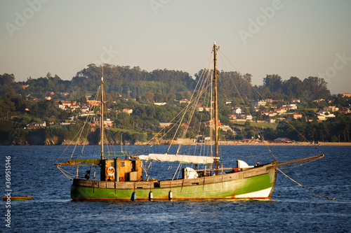 Velero antiguo de madera anclado en la ría de Sada en a Coruña, españa photo