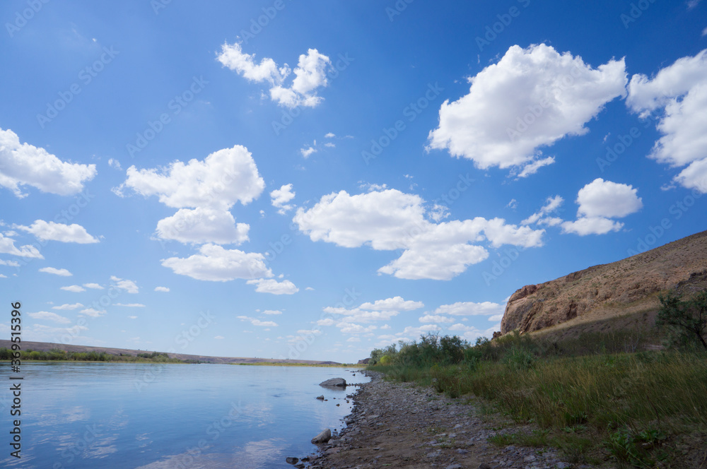 Beautiful clouds in the river valley. Beautiful blue sky with white clouds. landscape