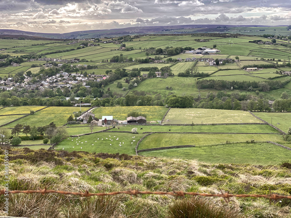 Landscape view, over fields and meadows, with farms and houses, in the distance near, Denholme, Bradford, UK