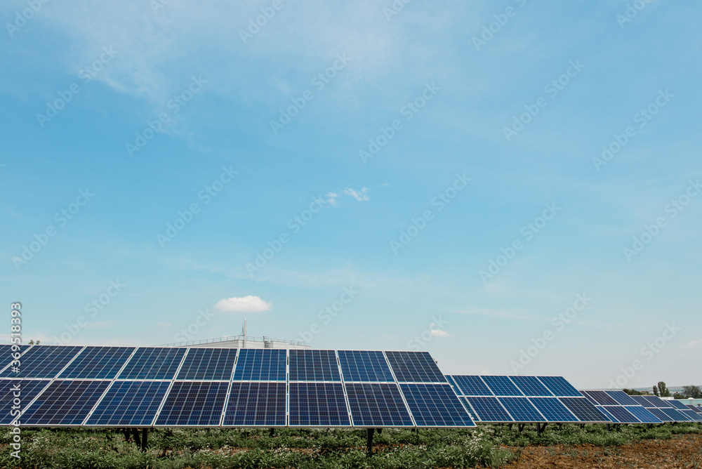 Photovoltaic power plant. Solar photovoltaic panels on blue sky background Photovoltaic power plant. Solar photovoltaic panels on blue sky background