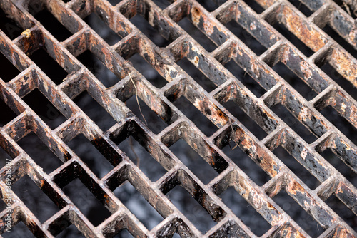 Rusty metal, steel or iron cage grating material object. Material background and texture photo.