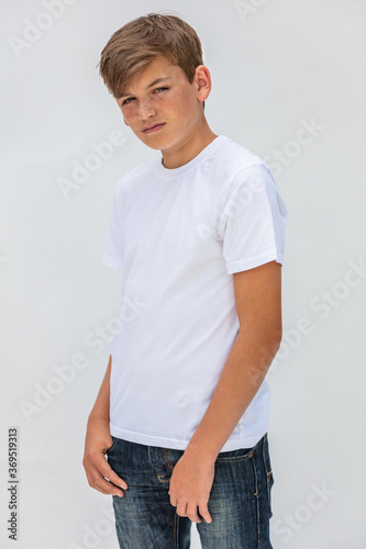 Boy teenager teen male child wearing a white t-shirt and jeans