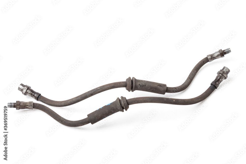 Pair of old brake hoses on white background in photography studio - a high pressure hose and two metal nozzles for connecting to the cylinders. Spare parts in a car service or for sale at auto parsing Pair of old brake hoses on white background in photography studio - a high pressure hose and two metal nozzles for connecting to the cylinders. Spare parts in a car service or for sale at auto parsing