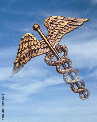 caduceus floating in blue sky 