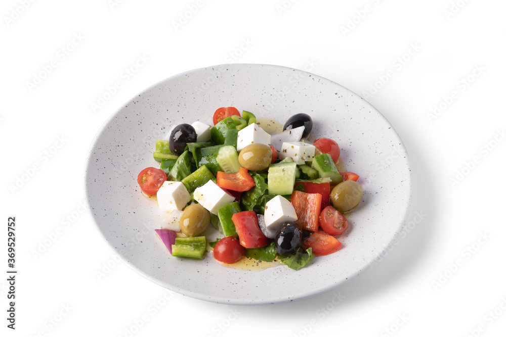 Greek salad on white plate for delivery, vegan food Greek salad on white plate for delivery, vegan food