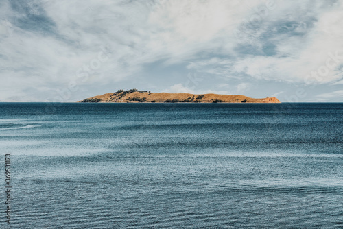 View of the Titicaca Lake on the border of Peru and Bolivia. By volume of water, it is the largest lake in South America.It is often called the highest navigable lake in the world.