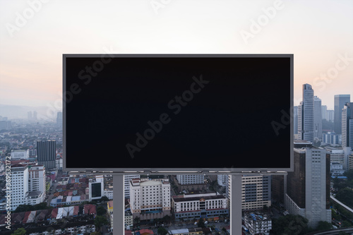 Photography Blank black road billboard with Kuala Lumpur cityscape background at sunset