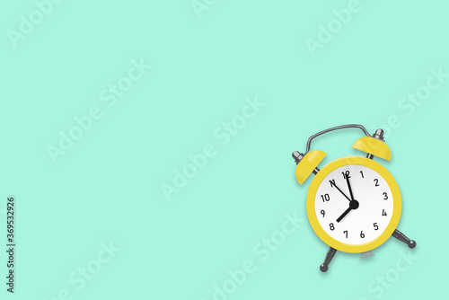 Yellow round alarm clock on the cyan background illustration