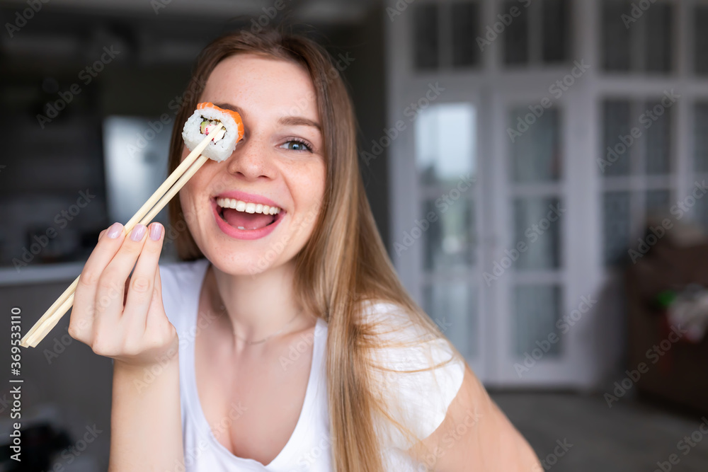 Female client holding food sticks and eating oriental meal on lunch. Female client holding food sticks and eating oriental meal on lunch.