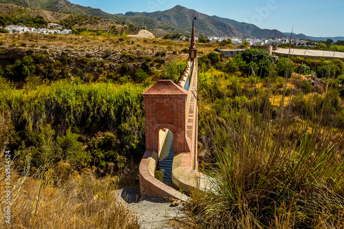 A view of irrigation water flowing along the majestic, four storey, Eagle Aqueduct that spans the ravine of Cazadores near Nerja, Spain in the summertime photo