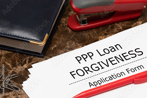 PPP loan forgiveness text on application form paper. Small Business Payroll Protection Program. photo
