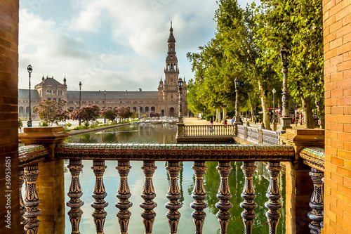 An early morning view along a canal in the Plaza de Espana in Seville, Spain in the summertime photo