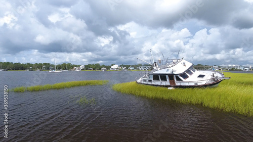 A boat sits stranded in the marshes of Carolina Beach, North Carolina following Hurricane Isaias. photo