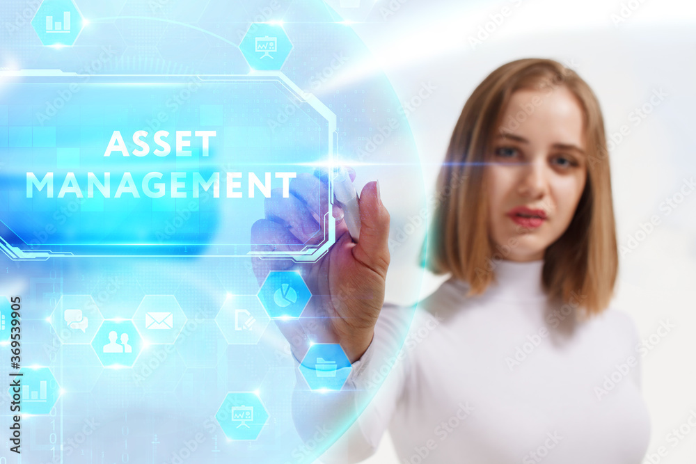 Business, Technology, Internet and network concept. Young businessman working on a virtual screen of the future and sees the inscription: Asset management