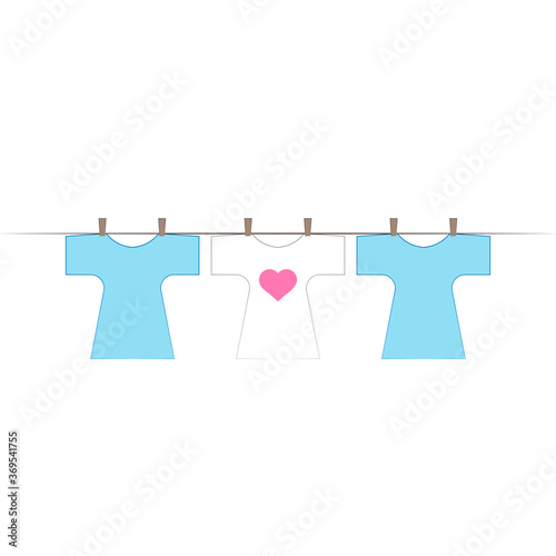 Shirts dry on a rope. The shirt has a heart pattern on it.