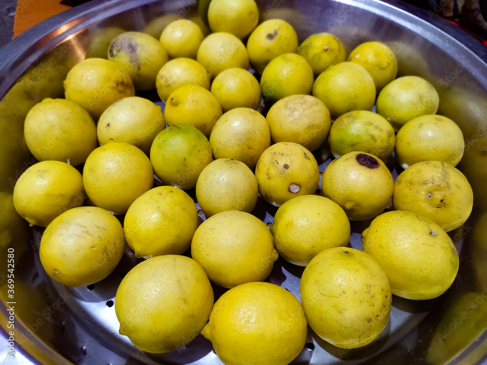 fresh yellow lemons in a bowl