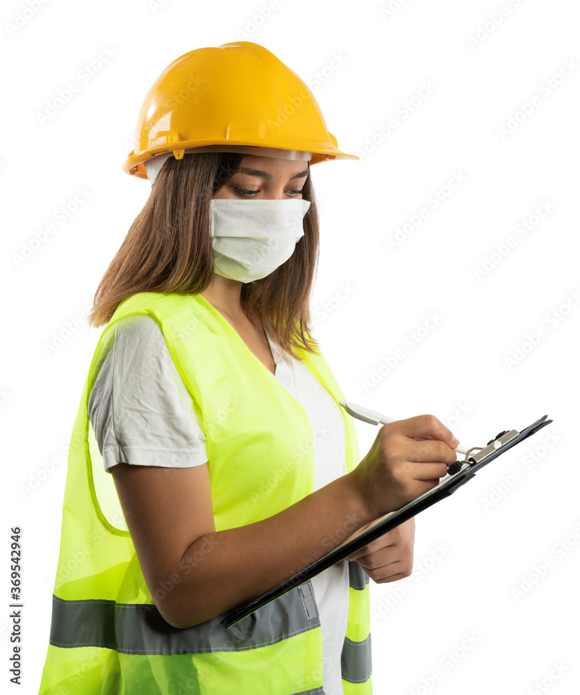 Amused young woman in yellow hardhat, green reflective vest and lumberjack shirt Amused young woman in yellow hardhat, green reflective vest and lumberjack shirt