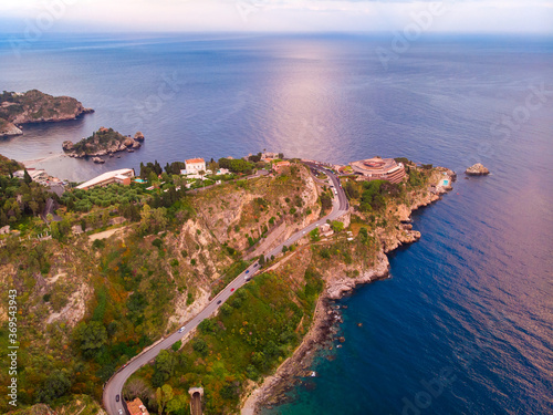 Taormina, Sicily Italy beach sunset, volcano Etna in clouds. Aerial top view. photo