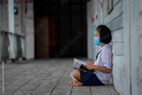 Portrait Asian children student wear face mask sitting at elementary school.