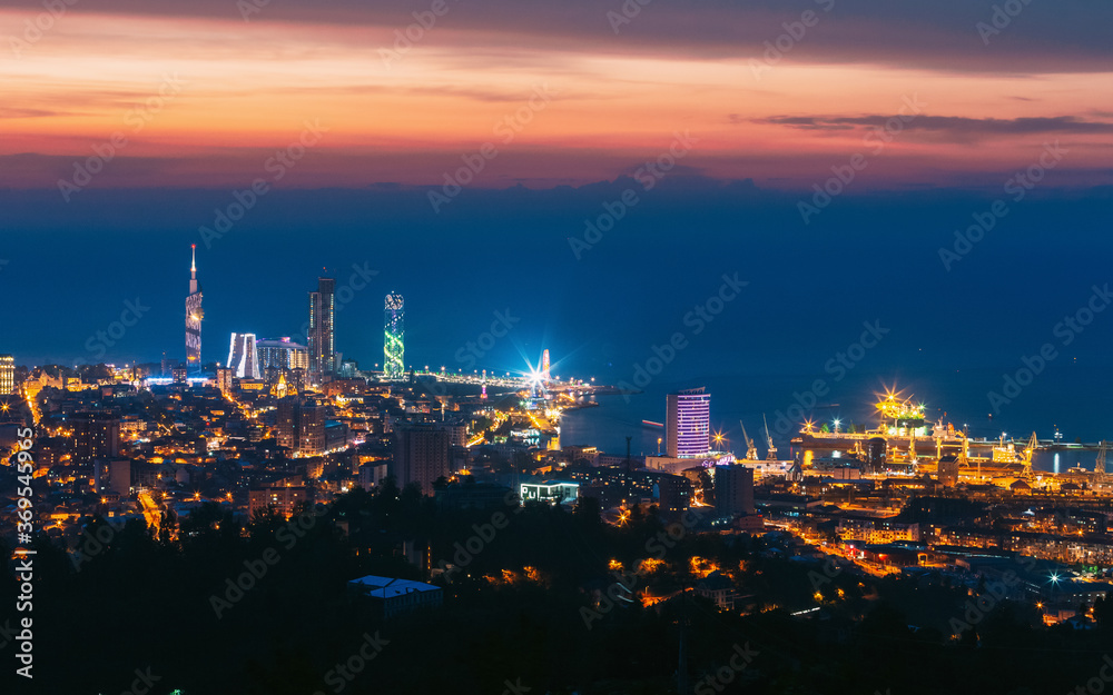 Batumi, Adjara, Georgia. Aerial View Of Urban Cityscape At Sunset. Town At Evening Blue Hour time. City In Night Lights Illuminations