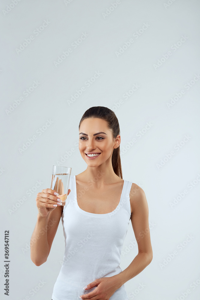 Portrait of beautiful woman with beauty face hold water glass. Drink water. Girl with glass of water. Diet concept Portrait of beautiful woman with beauty face hold water glass. Drink water. Girl with glass of water. Diet concept